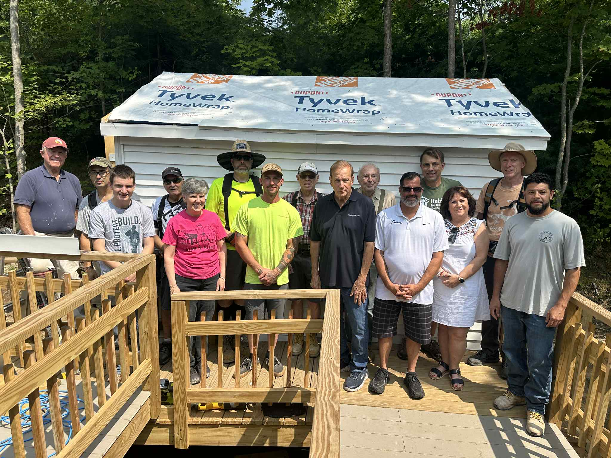 Image from nrinow.news: Staff and volunteers in front of a new shed.